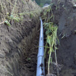 This is a typical LPP lateral during installation. Notice the sidewalls of the trench are excavated by a trencher to ensure a non-smeared surface for wastewater to enter the ground. After fitting the pipe we will install the stone under the pipe.