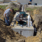 Installation of the vent pipe, pump, and electrical components of a pressure system.
