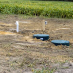Septic and dose tank with all components installed during backfill.
