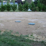 Final appearance around a gravity septic system tank.