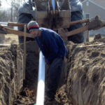 Installation of a gravity drainfield lateral pipe.