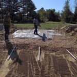 Sand Mound stone installation :: We are installing the stone, pipe, and typar. Typar is used to keep the stone clean of any dirt.