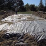 Sand Mound stone installation :: We are installing the stone, pipe, and typar. Typar is used to keep the stone clean of any dirt.