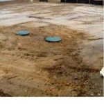 You can see how we try to leave positive drainage around our tanks to prevent rain from entering the risers.