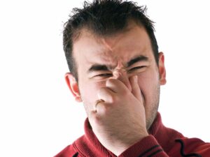 a man smelling a bad odor